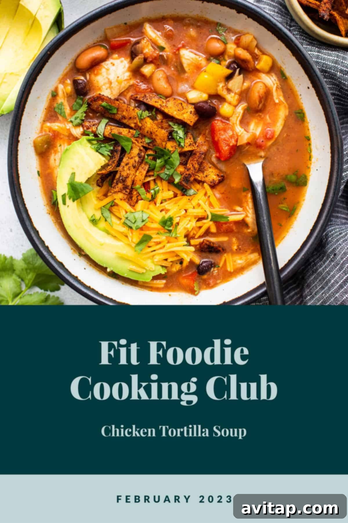 A vibrant bowl of slow cooker chicken tortilla soup, garnished with fresh cilantro and crunchy tortilla strips.
