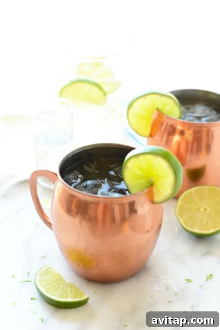 A refreshing Moscow Mule cocktail served in a classic copper mug, garnished with a lime wedge.