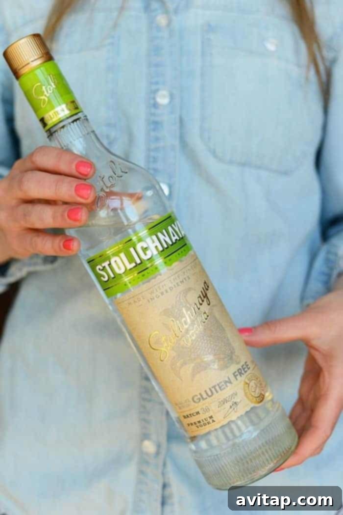A refreshing Moscow Mule cocktail served in a classic copper mug, elegantly garnished with a fresh lime slice and a sprig of mint, ready to be enjoyed.