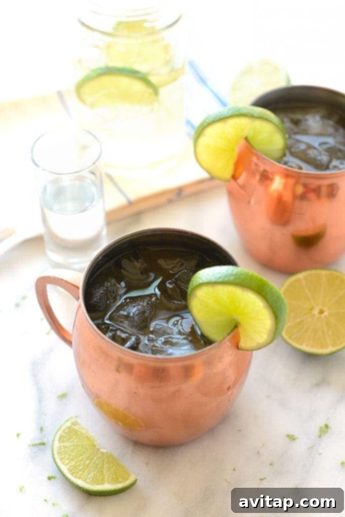 A perfectly prepared Moscow Mule in a gleaming copper mug, garnished with a fresh lime wedge, ready to be served and enjoyed, highlighting its refreshing appeal.