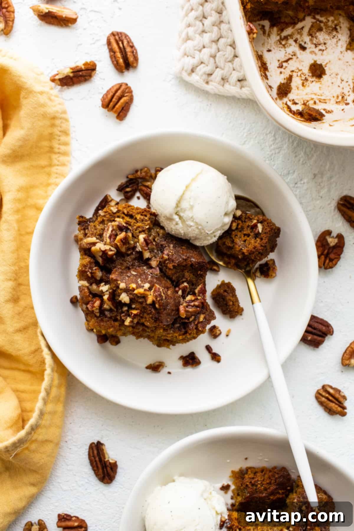 Warm pumpkin bread pudding served à la mode with a scoop of vanilla ice cream, creating a perfect contrast.