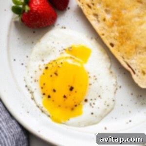 A sunny side up egg on a plate.