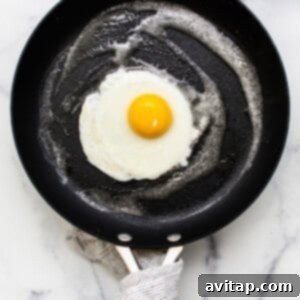 A perfectly cooked egg in a pan.