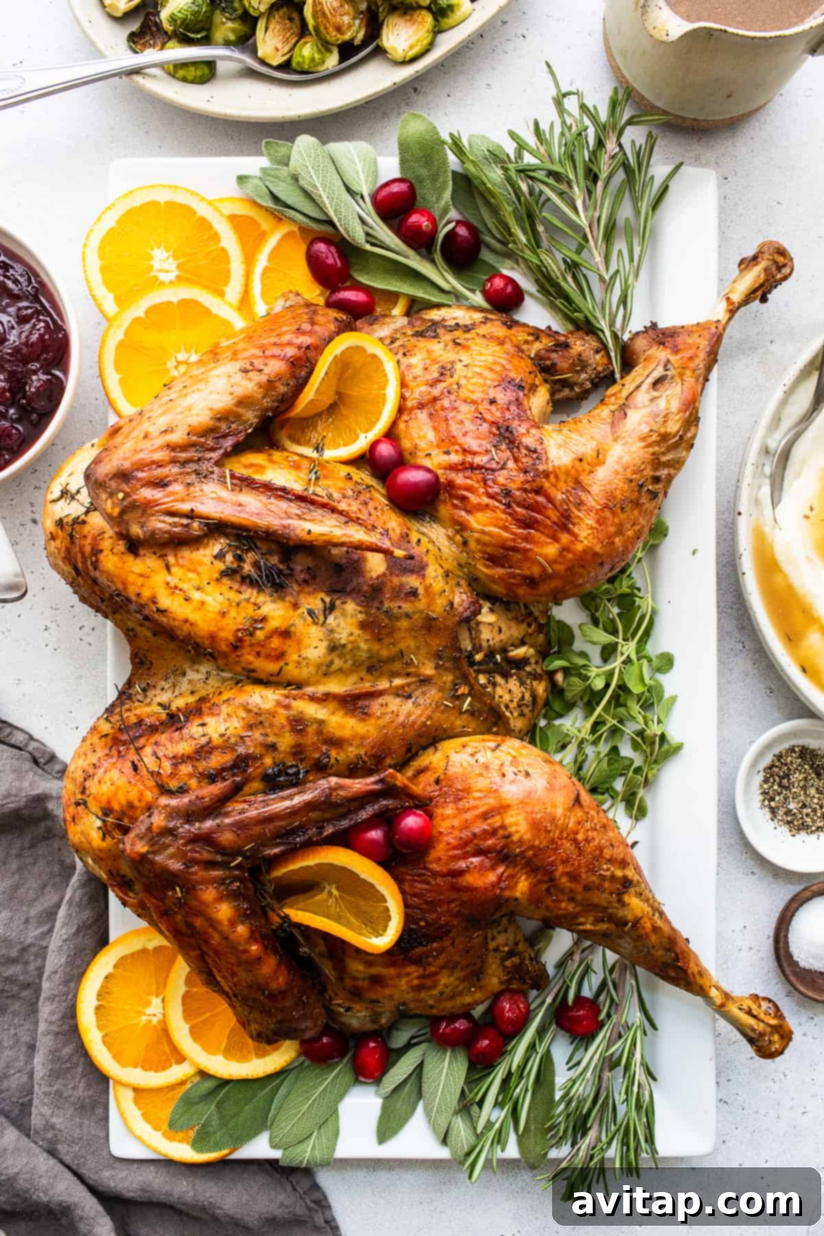 Learn how to spatchcock a turkey and then roast it to perfection. This spatchcock turkey recipe leaves you with the juiciest herbed turkey meat and super crispy skin. Spatchcock turkey on a plate, perfectly roasted with crispy skin and juicy meat.