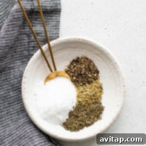 A white bowl with salt, pepper, and herbs for the dry brine mixture.