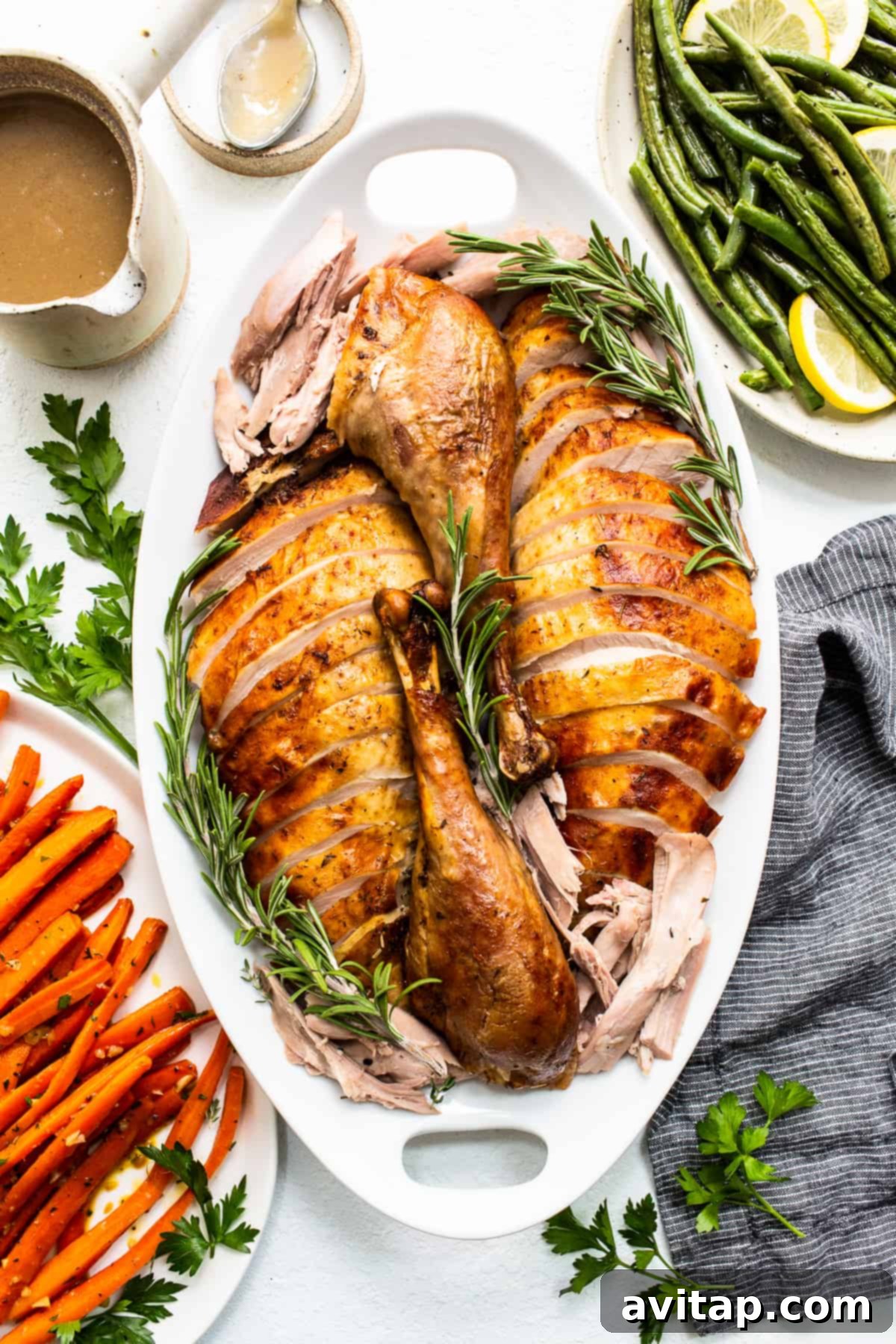 Perfectly sliced, juicy Thanksgiving turkey arranged on a platter, ready to serve.