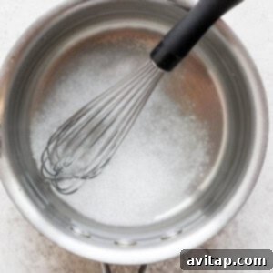Salt dissolving in water in a saucepan over medium heat.
