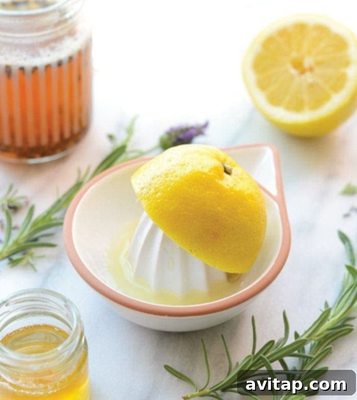 The Secret to Great Lemonade: Fresh Lemon Juice Fresh lemons being squeezed on a citrus juicer, highlighting the importance of fresh ingredients for lemonade, with a jar of honey nearby.