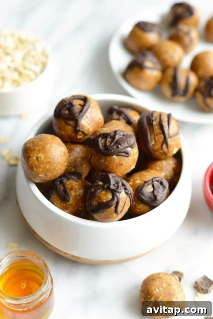 Irresistible Peanut Butter Energy Balls: A Delightful Healthy Treat A bowl filled with freshly made peanut butter energy balls, garnished with a sprinkle of sea salt and a drizzle of melted dark chocolate.