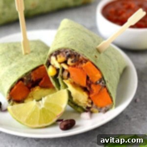 A plate with two freshly prepared black bean breakfast burritos, showcasing the delicious filling.