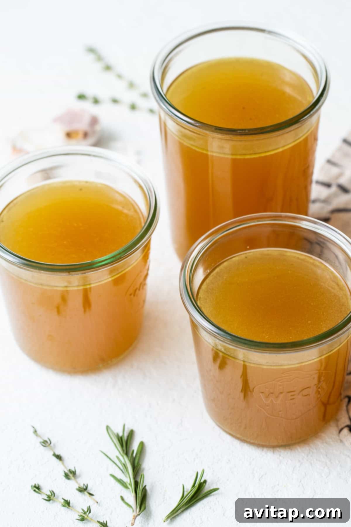 Liquid Gold Turkey Stock 2 Homemade turkey stock bottled in glass jars, ready for storage or use.