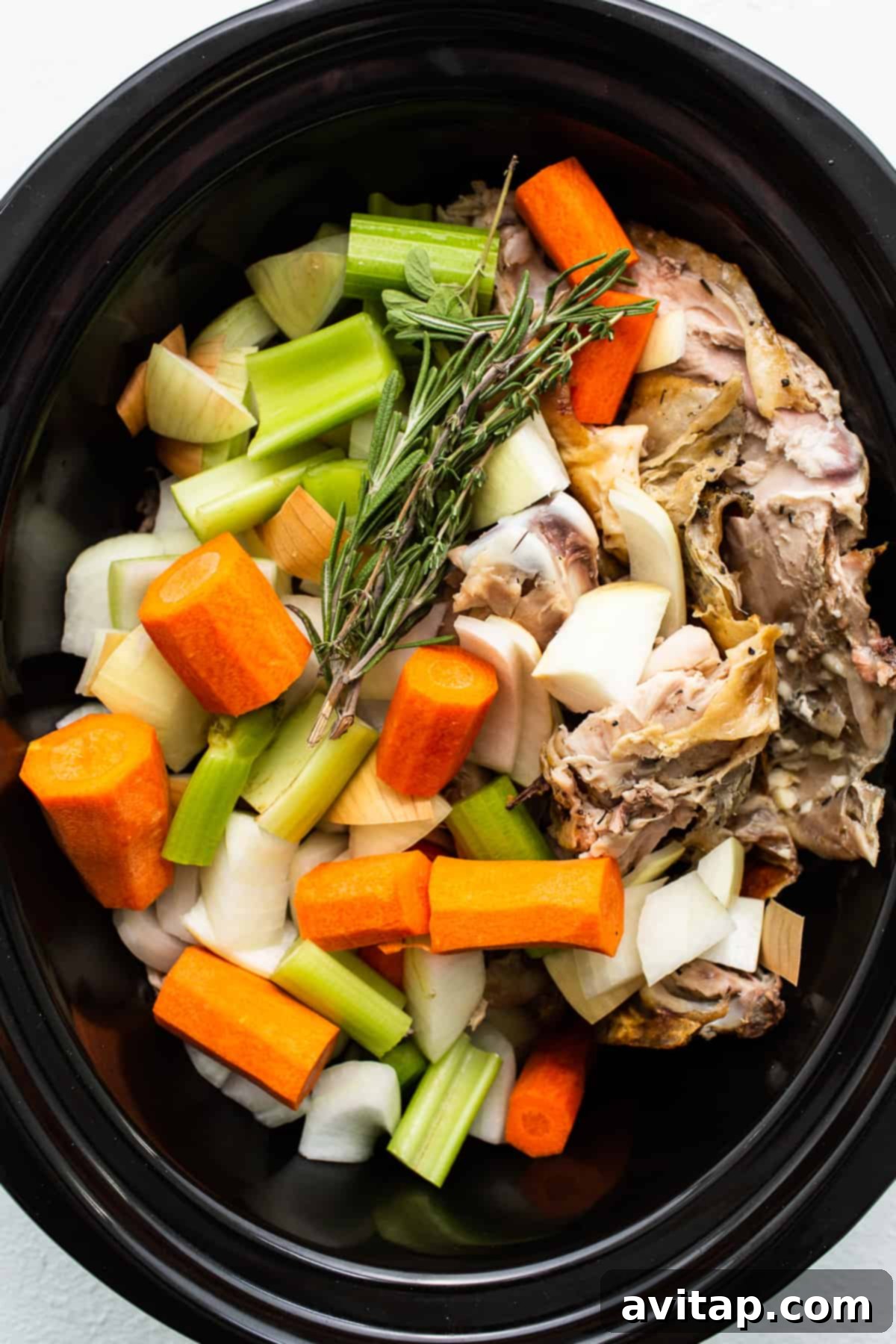 Liquid Gold Turkey Stock 4 All the essential ingredients for homemade turkey stock nestled in a slow cooker, ready for simmering.