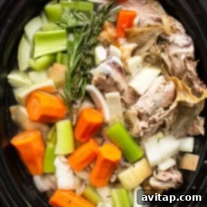 Homemade turkey broth simmering in a crockpot, rich in color and nutrients.