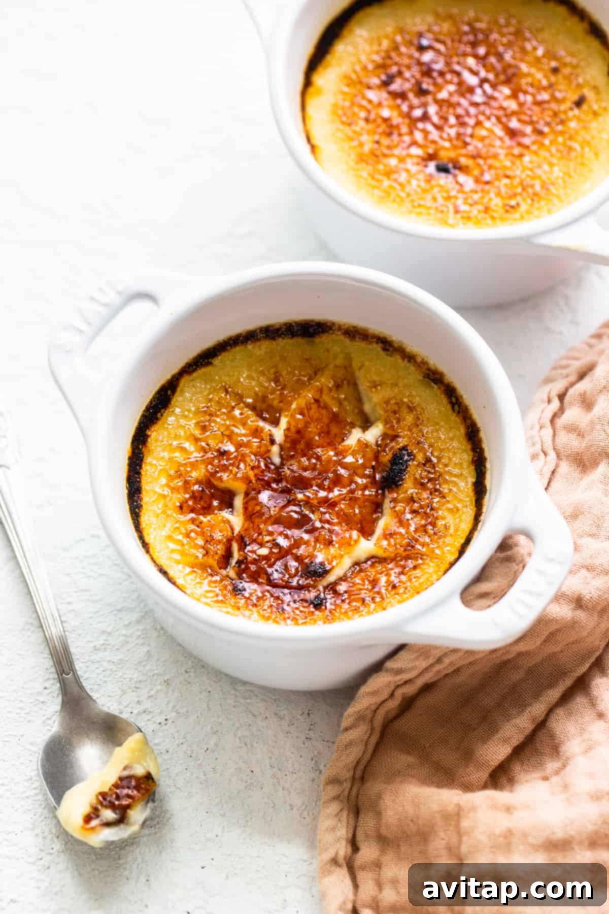 Eggnog Creme Brûlée with a perfectly cracked caramelized sugar top, ready to be enjoyed.