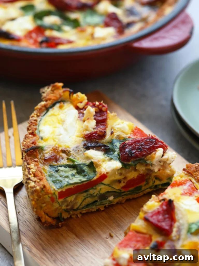 15 Delicious Breakfast Egg Recipes 13 A generous slice of savory sweet potato crust quiche on a wooden cutting board, with a fork.