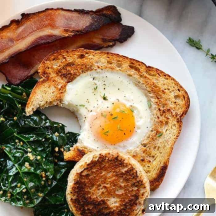 15 Delicious Breakfast Egg Recipes 15 A classic 'Egg in a Frame' breakfast, with a fried egg nestled perfectly within a toasted slice of bread, on a plate.