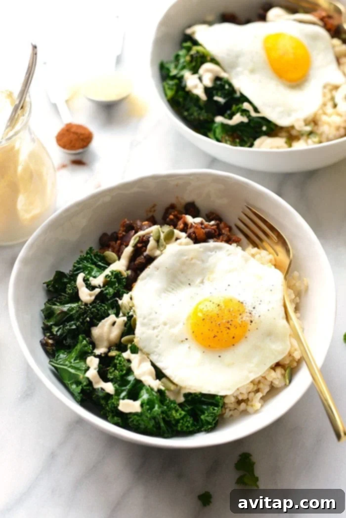 15 Delicious Breakfast Egg Recipes 17 A vibrant and hearty black bean breakfast bowl, layered with scrambled eggs, avocado, salsa, and fresh cilantro.