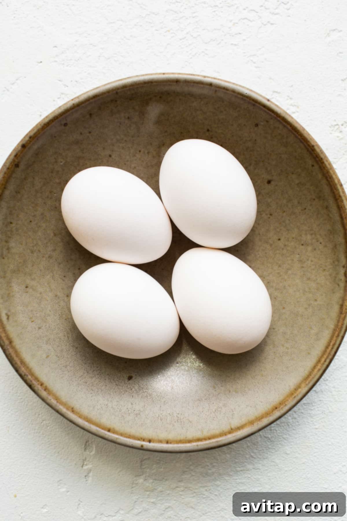 Quality ingredients are key to delicious over easy eggs. Fresh eggs in a bowl, ready for cooking.
