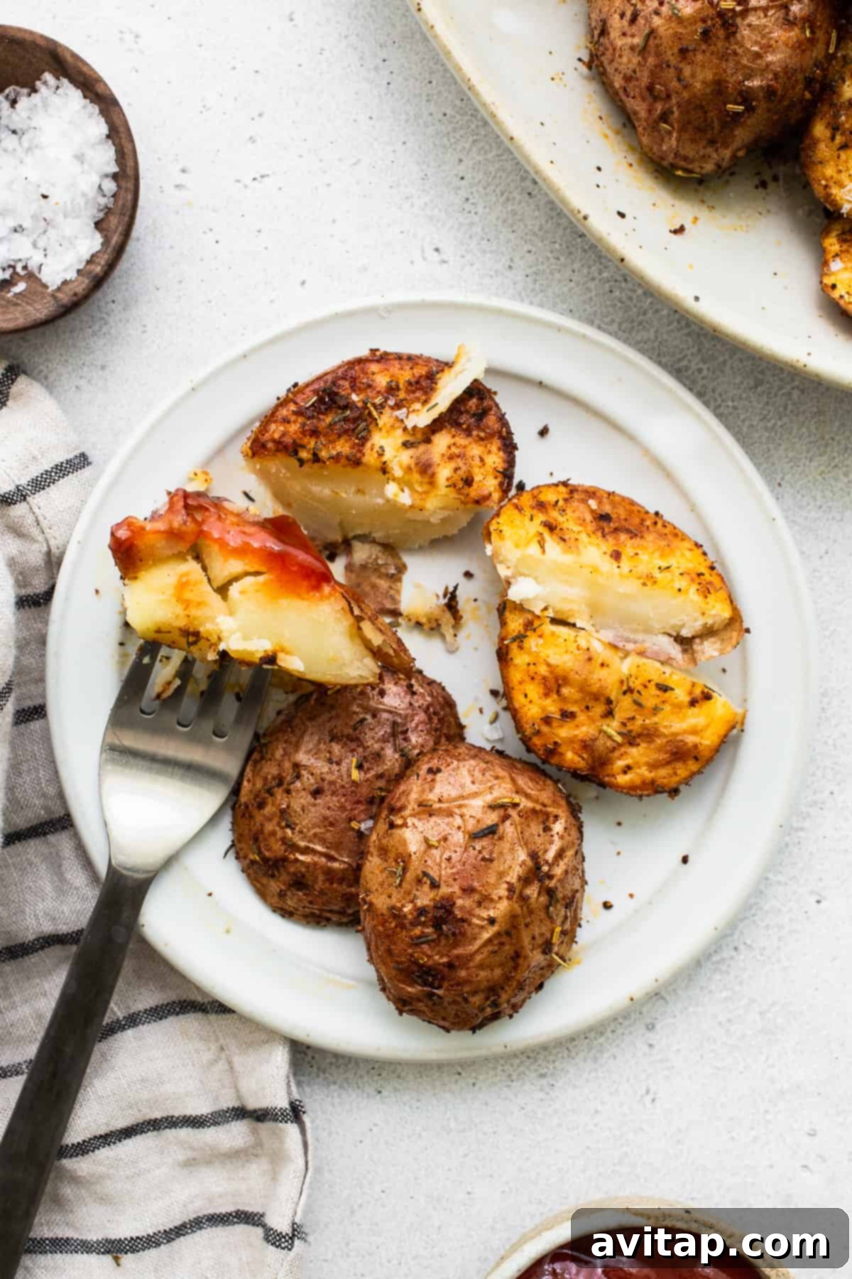 Crispy Air Fryer Potatoes with Ketchup A generous serving of crispy air fryer potatoes on a plate, with a side of ketchup for dipping.