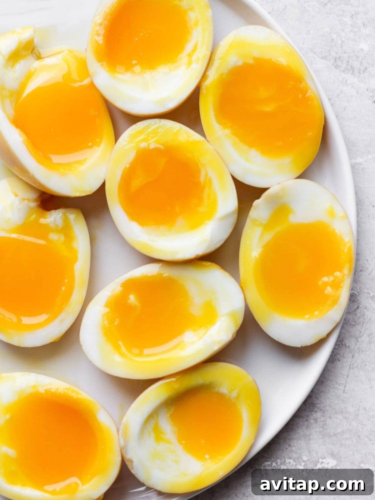 Soft boiled eggs served elegantly on a plate with fresh herbs and seasoning.