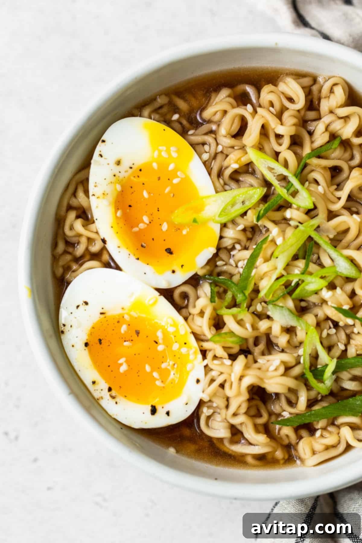 Soft boiled eggs elegantly placed in a bowl of ramen, ready to be enjoyed.