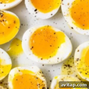Soft boiled eggs on a serving plate, ready to be eaten.