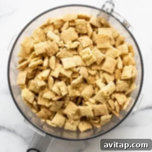Chex cereal in a bowl on a marble countertop.