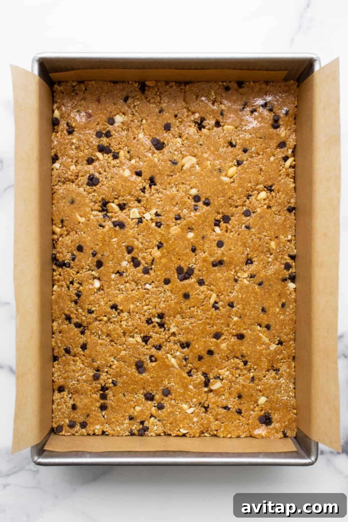 No bake peanut butter bars pressed into a cake pan.