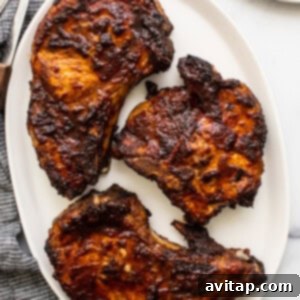 A perfectly cooked, golden-brown air fryer pork chop, ready to be served.