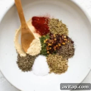 Spices in a white bowl with a wooden spoon, ready for the bolognese sauce.