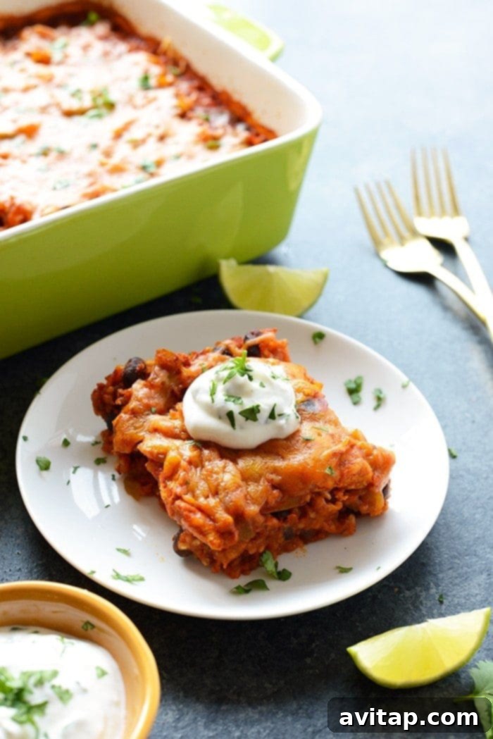 A vibrant, healthy chicken enchilada casserole featuring lean chicken, black beans, colorful bell peppers, and brown rice, freshly baked and ready to serve.