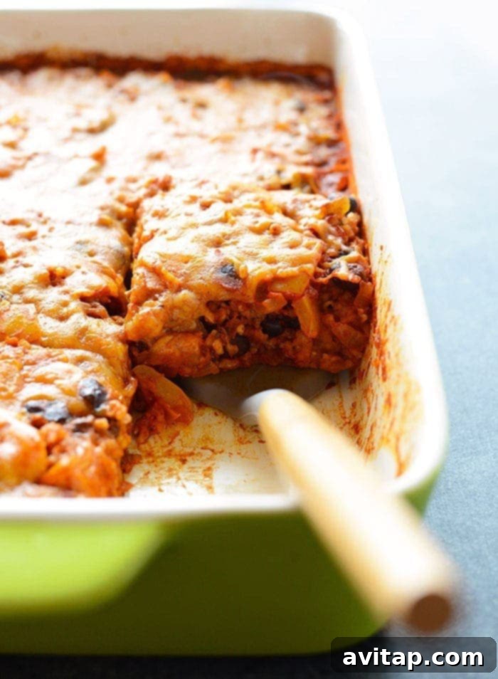 A close-up shot of the chicken enchilada casserole, highlighting the rich sauce and tender ingredients, ready to be served.