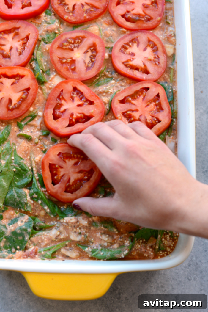 A lightened spinach quinoa lasagna casserole, baked to perfection, offering a no-hassle, protein-packed, gluten-free, and flavorful dinner option.