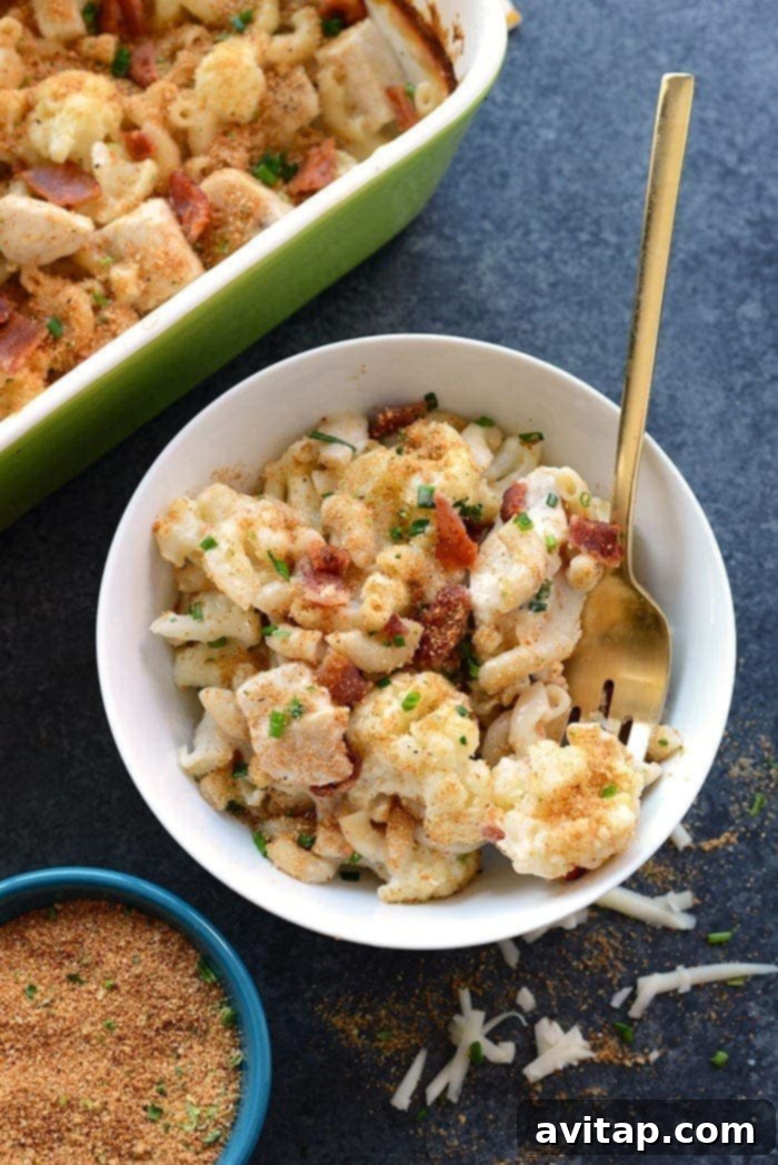 Creamy Cauliflower Chicken Mac and Cheese 2 Delicious serving of cauliflower chicken mac and cheese in a bowl, showing creamy texture and golden crust.