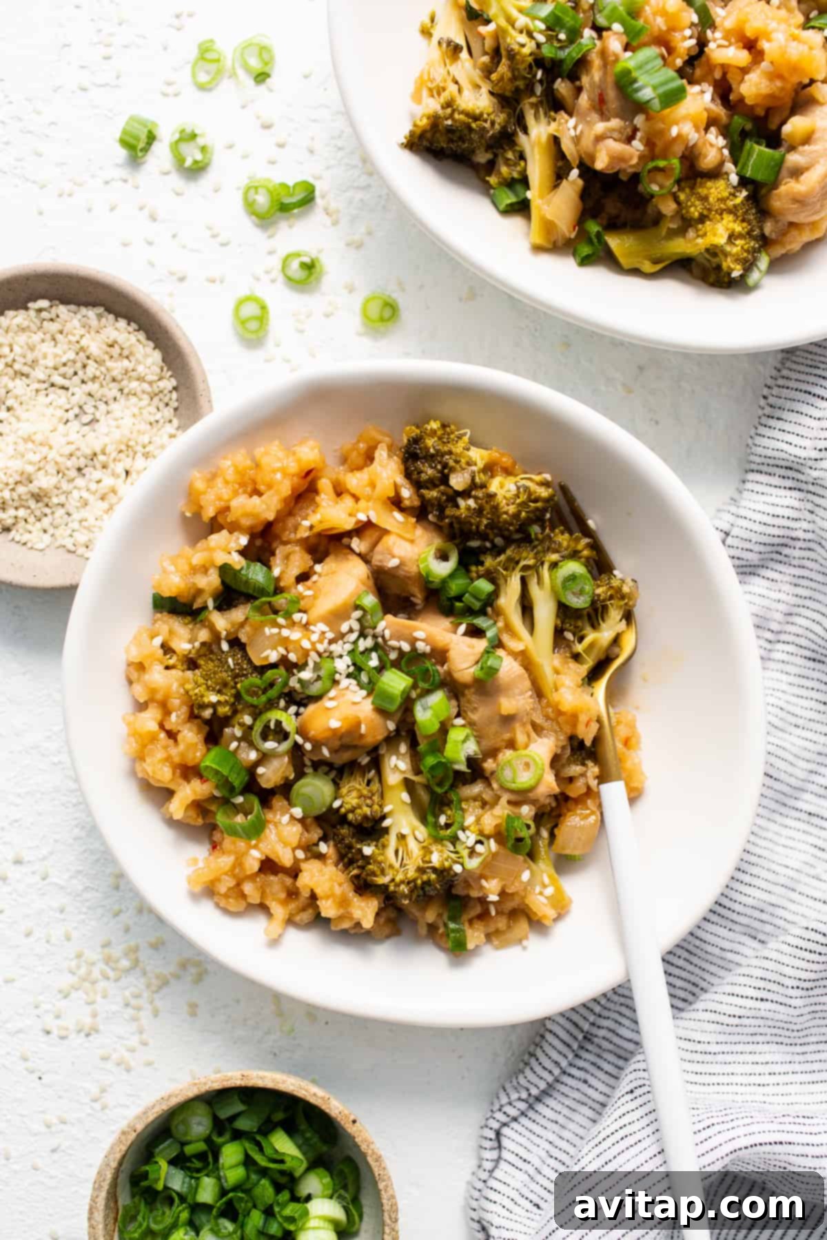 Orange Chicken Casserole: A perfect blend of takeout flavor and home-cooked ease. Delicious Orange Chicken Casserole served in a bowl, garnished with green onions and sesame seeds.
