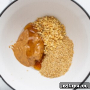 All the peanut butter and quinoa cup ingredients thoroughly mixed in a large bowl.