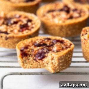 A delicious peanut butter and jelly quinoa cup with a bite taken out, showing the layered texture.