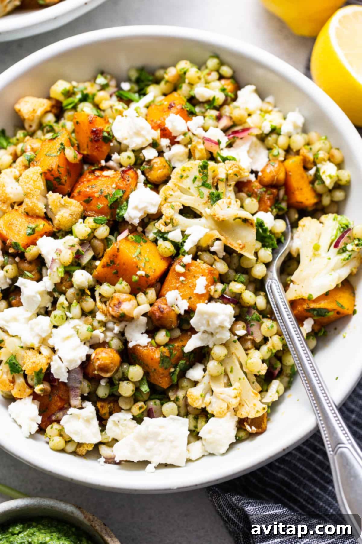 Israeli Couscous Medley 7 A large serving bowl filled with the completed Israeli couscous salad, garnished and ready to serve.