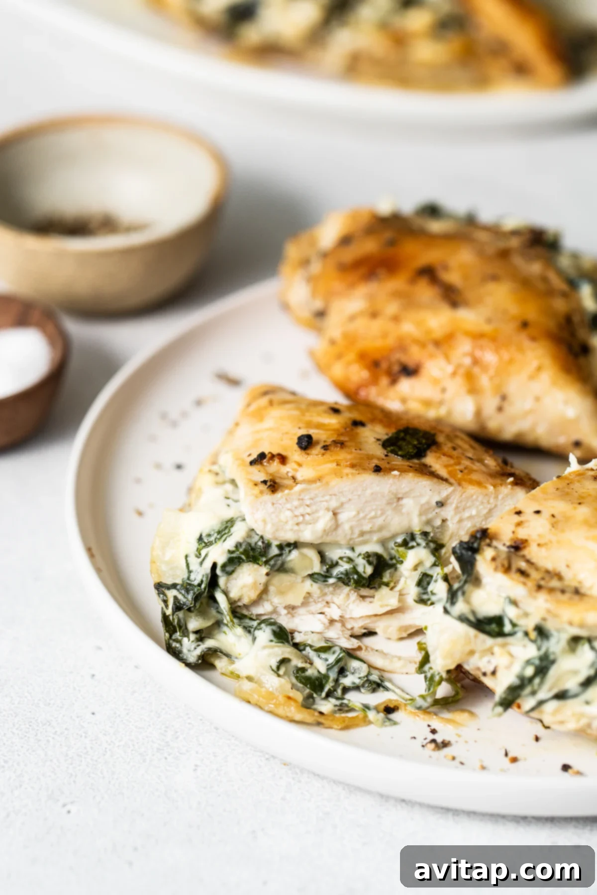A beautifully plated spinach stuffed chicken breast, garnished and ready for serving, highlighting its appealing presentation.