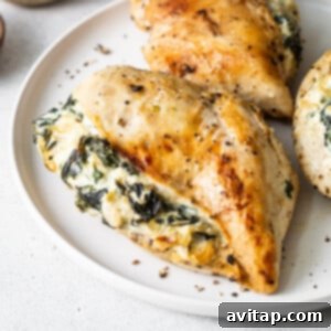 A close-up of a beautifully cooked spinach stuffed chicken breast, showcasing its golden exterior and rich filling.