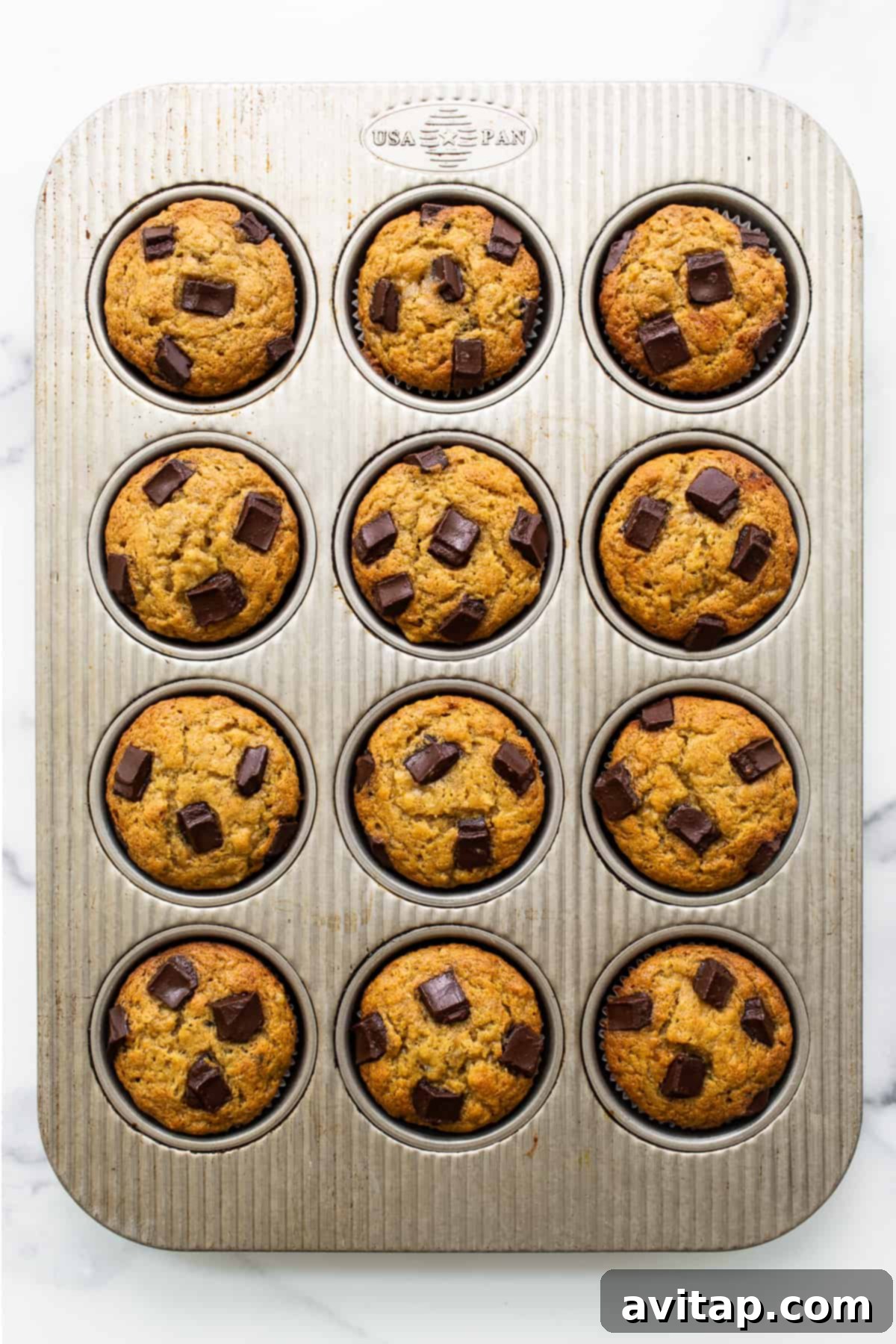 A close-up of the delicious protein muffin batter mixed with chocolate chunks, ready for baking.