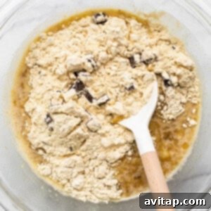 A bowl of ingredients with a wooden spoon in it.