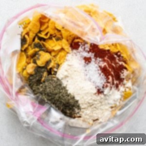 A plastic bag filled with various dry ingredients for chicken breading.