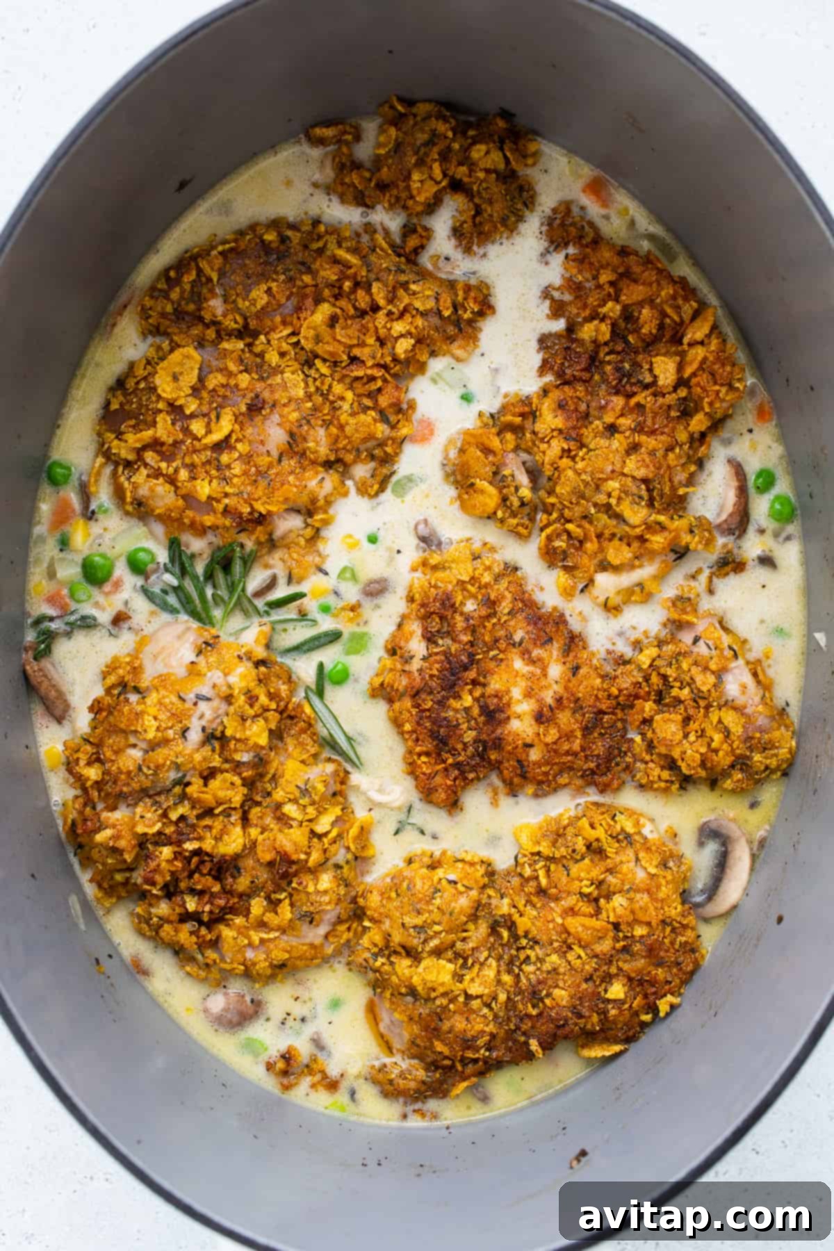 Chicken pot pie skillet in a cast-iron skillet, covered and ready for baking.