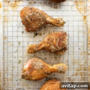 Roasted chicken legs on a cooling rack.
