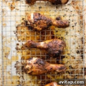 Roasted chicken legs on a cooling rack.