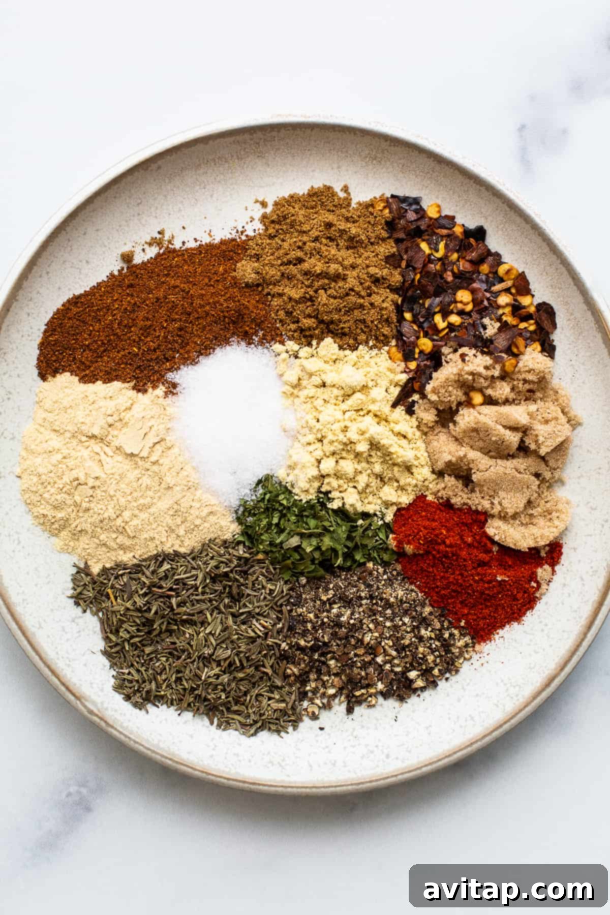 A small bowl filled with homemade chicken seasoning blend, ready for use.