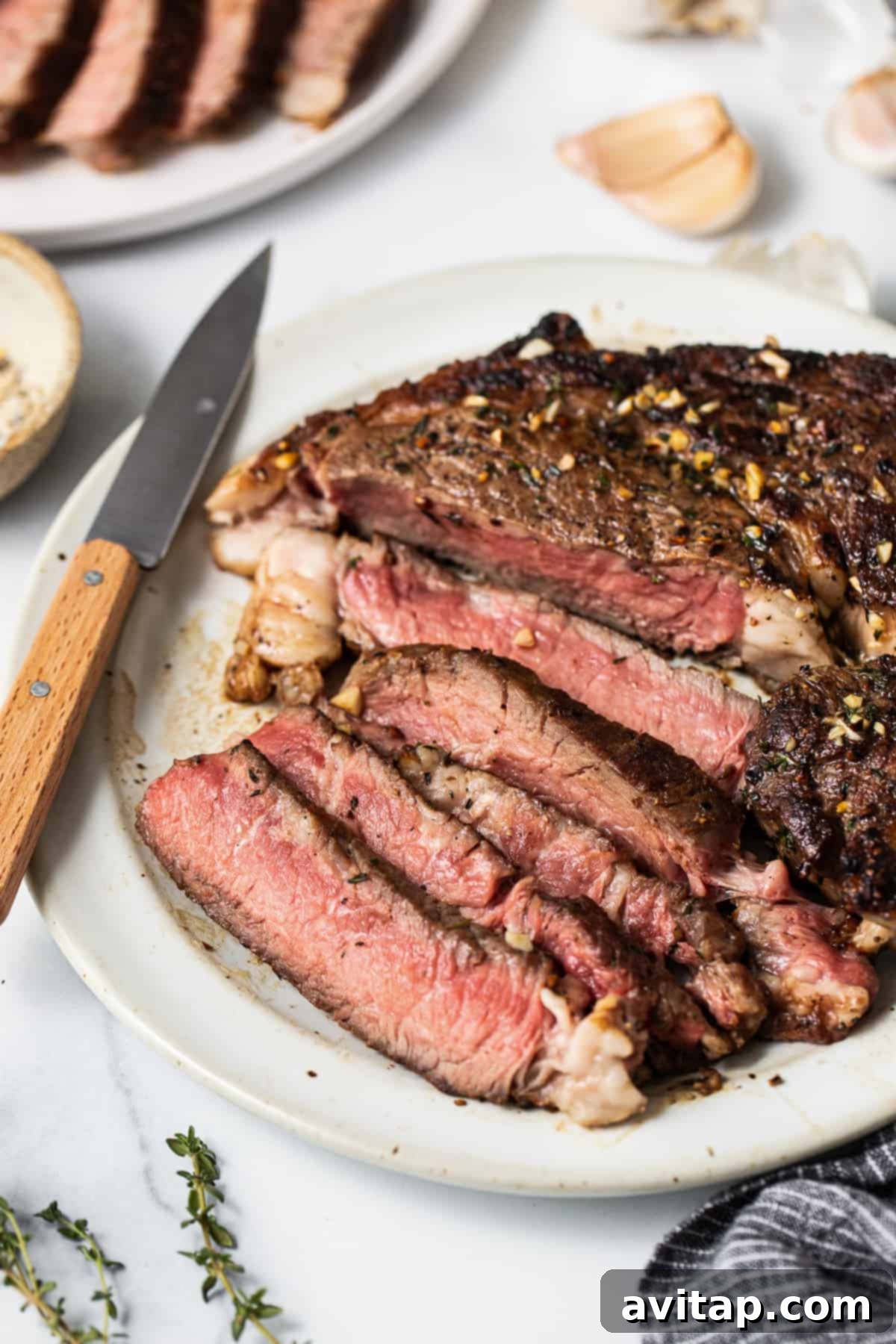 Perfect Cast Iron Steak 7 Perfectly sliced cast iron steak served on a plate, ready to enjoy.