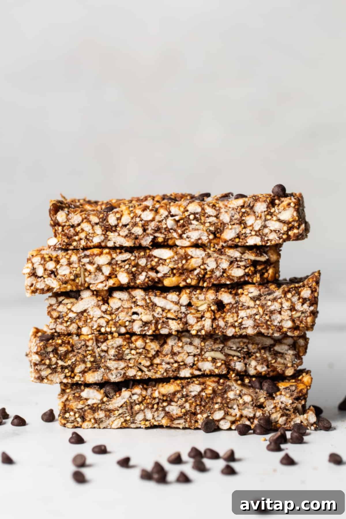 Stacked homemade nut and coconut bars, showcasing their crunchy texture and visible ingredients.