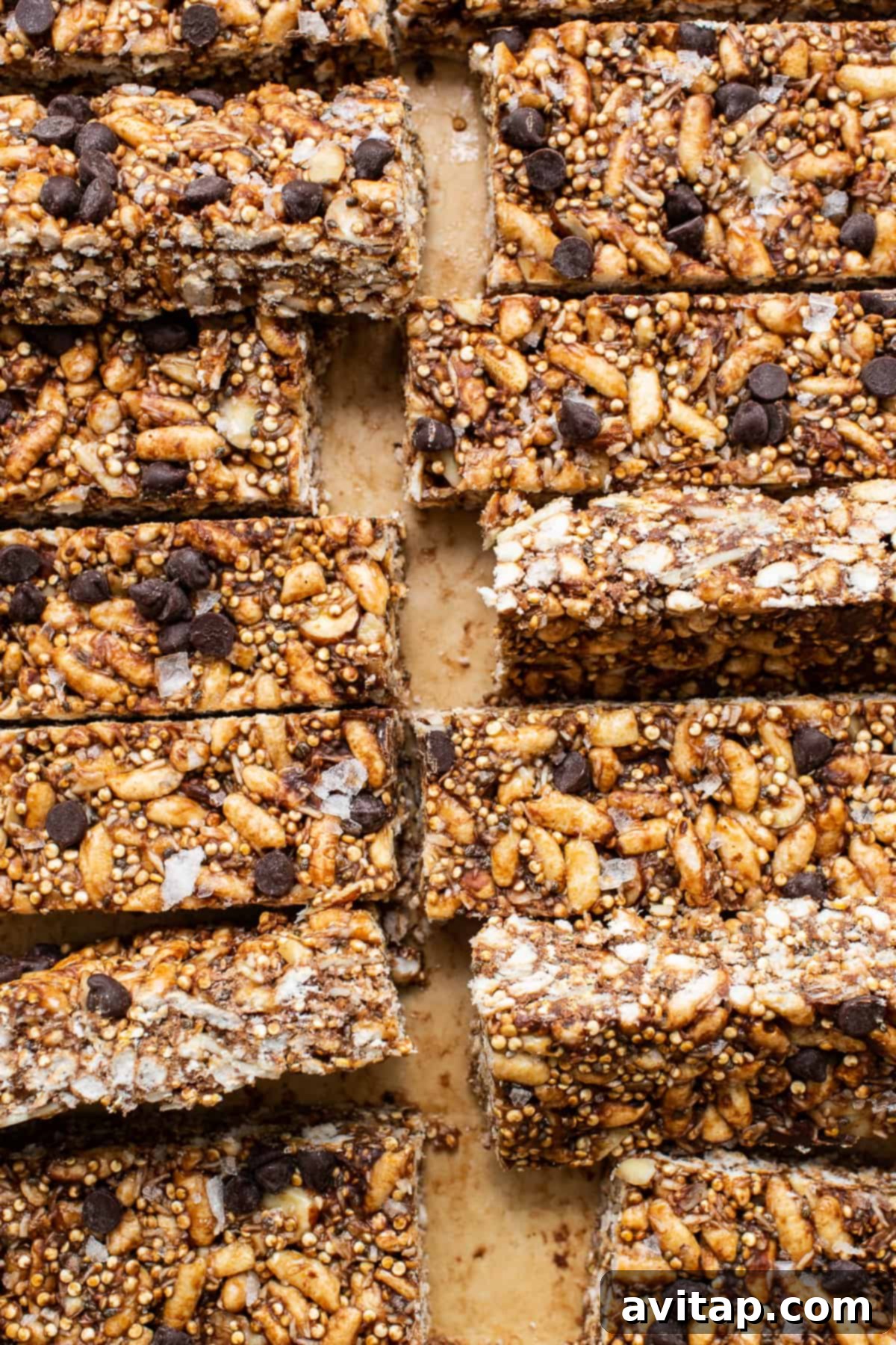 Perfectly sliced nut and coconut bars arranged on a cutting board, highlighting their layers.